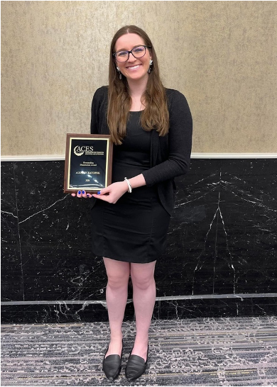 Photo of Dr. Audrey Zatopek with award.